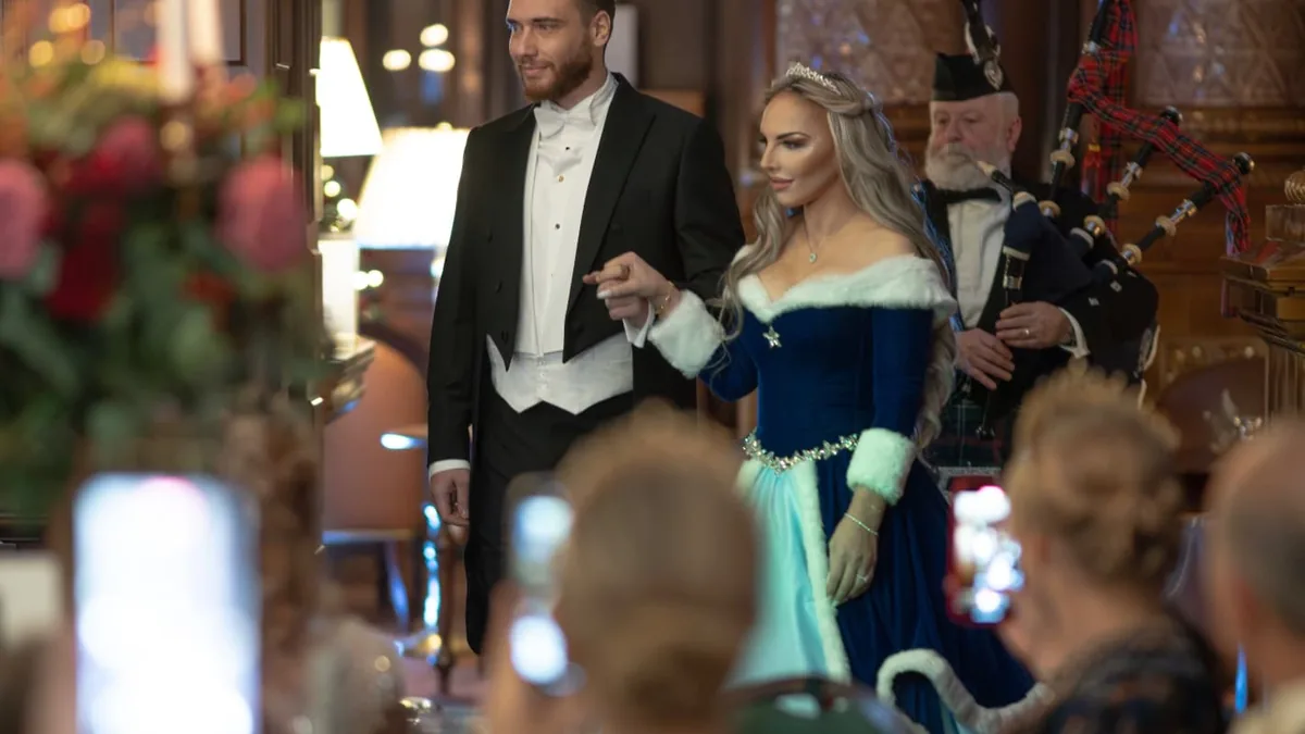 Guests in white tie in conversation on arrival at The Winter Banquet